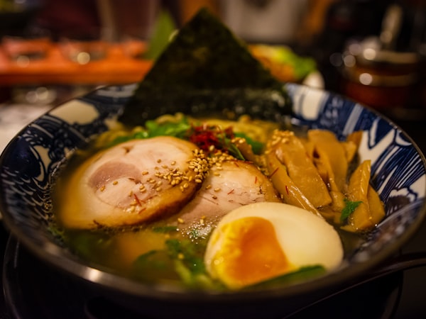 Bowl of miso ramen with soft-boiled egg, chashu pork, nori, and green onions